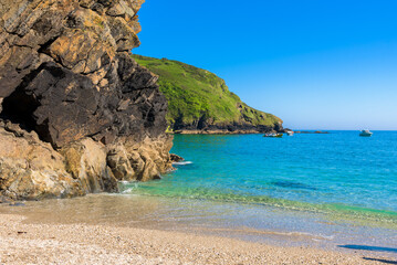 Stunning coastline and beach at Lantic Bay. Crystal clear turquoise sea water in Cornwall, England.