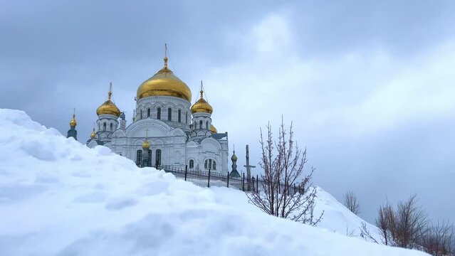 Belogorsky St. Nicholas Orthodox Missionary Monastery. Russia, Perm Krai, Belaya Gora. The temple on the hill in winter. Monastery on the background of snow. 4K