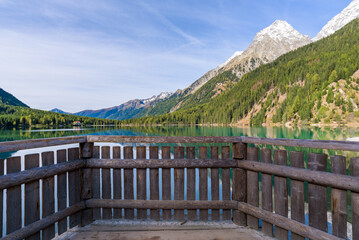 Morning light and still water with reflections at Lake Anterselva, also known as AntholzerSee or Lake Antholz, in South Tyrol, Italy.