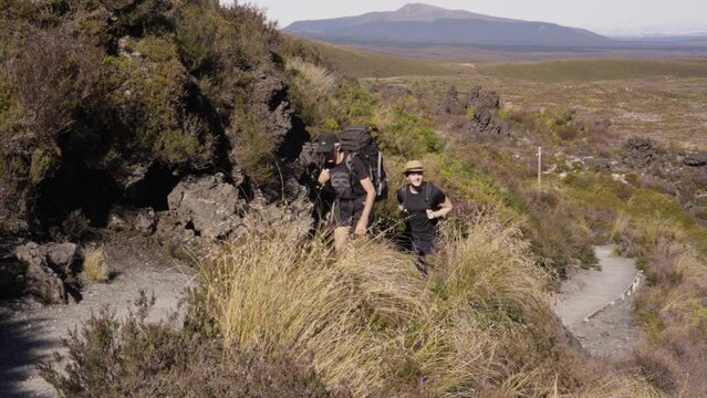 Backpackers On The Mountain Trails Of Tongariro Alpine Crossing In New Zealand. Slow Motion