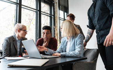 Group of casual team workers and programmers in the office working on a new project. 
