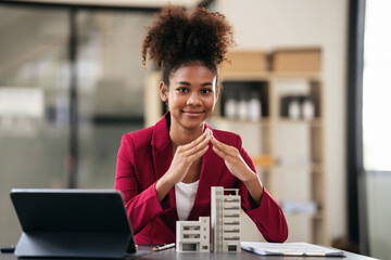African american businesswoman in suit using hands to protecting