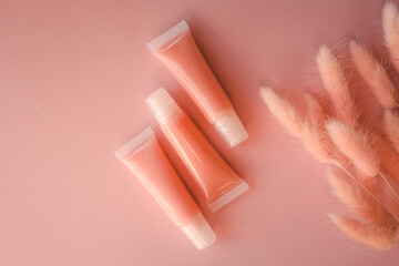Lip glosses on pink background