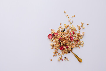 Granola on spoon isolated on white background, copy space. Healthy snack or breakfast concept -...