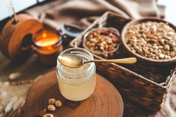 Fototapeta na wymiar Jar with natural honey on granola background, good morning concept