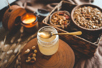 Jar with natural honey on granola background, good morning concept