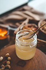 Jar with natural honey on granola background, good morning concept