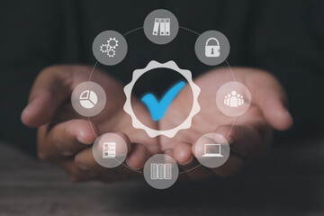 Man holding quality assurance icon or QA and Quality Control or QC.