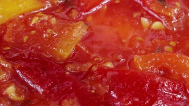 Bell peppers, tomatoes and paprika vegetables as a traditional Hungarian dish called lecs&oacute; in a spoon close up