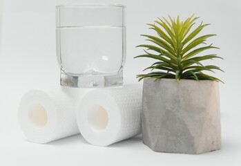 A glass of drink water and filter cartridges at white background