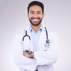 Doctor, man with arms crossed and happy in portrait, health and medical professional on studio background. Male physician, cardiovascular surgeon with stethoscope, happiness in medicine and mockup