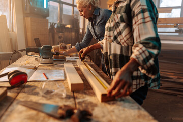 Female entrepreneurs working in wood workshop.
