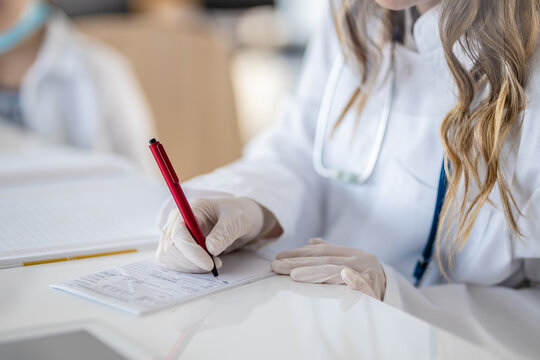 A doctor signing medical records