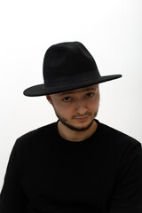 young man wearing a hat  seriously looking