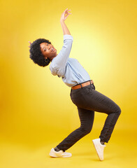 Portrait, dance and black woman with energy, celebration and freedom against a studio background....