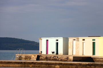 Fototapeta na wymiar Colorful changing cabins, landmark on beach Jadrija, in Sibenik, Croatia.