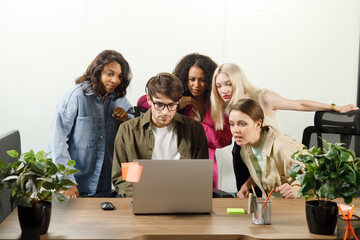 multiracial employees in office listening attentively online meeting conversation training