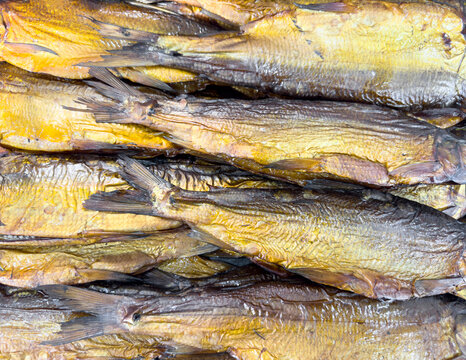 Hot smoked mackerel fish pattern. Smoke. Smoked meat. Smoked fish. Smoking room cooked at the stake. Smoked fish background texture