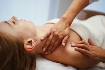 Fototapeta na wymiar Face massage. Young pretty woman having face massage in the salon