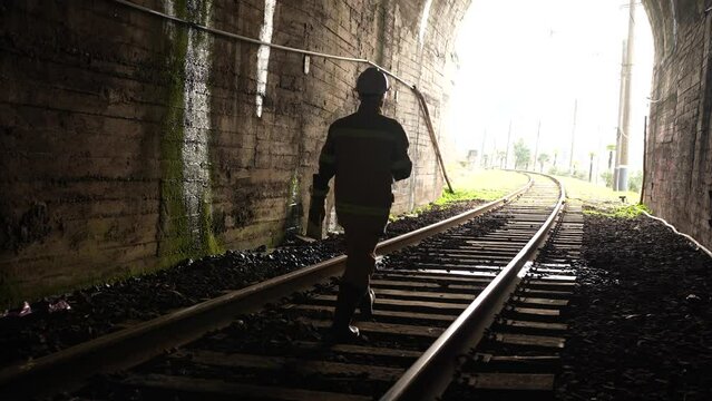 tunnel inspection a railway engineer with a lantern in his hands goes through the tunnel checks water leakage problem
