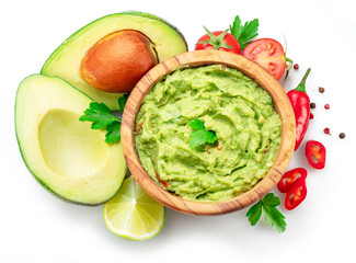 Guacamole bowl and guacamole ingredients isolated on white background. Flat lay.