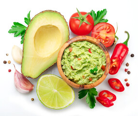 Guacamole and guacamole ingredients isolated on white background. Flat lay.