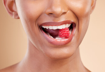 Woman, mouth and raspberry for skincare nutrition, dermatology or diet health plan against a studio...