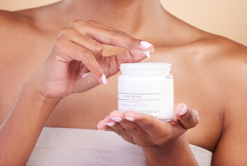 Hands, skincare or woman with cream product for beauty or wellness isolated on studio background....