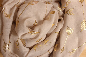Pile of Cream Colored and Gold Chiffon Fabric overhead view