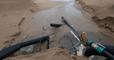 Industrial wastewater, the pipeline discharges liquid industrial waste into the sea on a city...