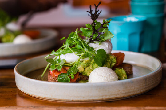 healthy breakfast with egg, avo, goat curd and greens