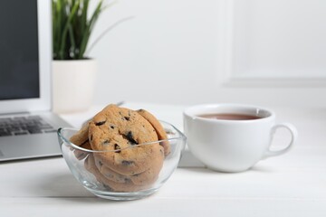 Chocolate chip cookies on white wooden table in office
