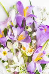 Close up bouquet of different spring flowers. Festive background. Top view, vertical photo.
