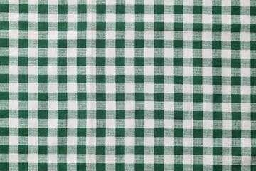 Green checkered tablecloth as background, top view