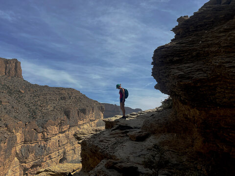 Woman Hiking the balcony trail in Jabal Shams the"Grand Canyon of Oman.