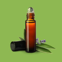 Bottle of lavender sage essential oil, leaves and flowers on light green background