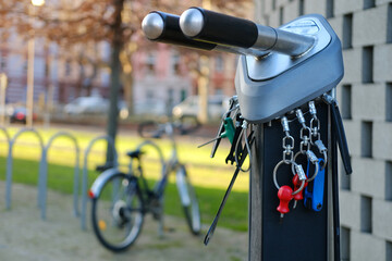 screwdrivers, wrenches, tire pump, quick repair tool public, free terminal to repair bicycles, bicycle in urban landscape, punctured wheel problem, vehicles in city, public bike rental, saddle sharing