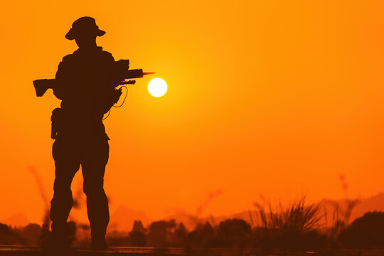 silhouette of soldier with rifle.soldiers in the uniform.soldier in action.