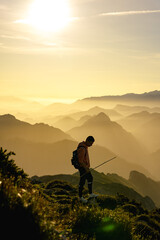 Fototapeta premium Hiker in the mountain during a gold sunset