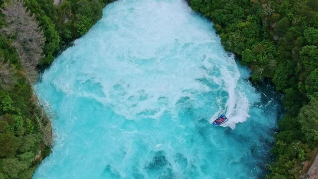 Stunning aerial wide angle drone footage of Huka Falls waterfall in Wairakei near Lake Taupo, North Island, New Zealand. The waterfall is part of the Waikato River and is a major tourist attraction.