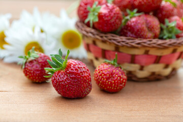 Ripe juicy strawberries on a wooden table. Healthy food rich in fiber, vitamins, antioxidants. Vegetarian food.