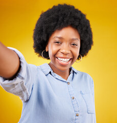 Portrait, selfie and black woman in studio happy, smile and confident against yellow background. Face, social media and girl influencer posing for photo, profile picture or blog update or vlog post