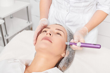 Cosmetologist makes mesotherapy injection for rejuvenation woman face, anti aging non surgical...