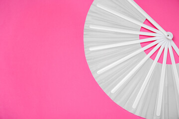 Stylish white hand fan on pink background, top view. Space for text
