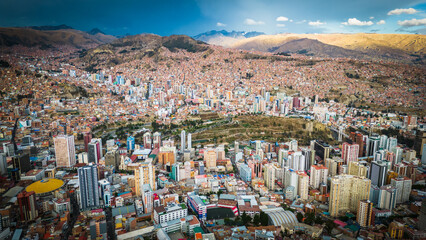Aerial Drone Fly Above La Paz, Bolivia,  Crowder Metropolitan City, Houses, Skyscrapers and Andean Cordillera Mountain Range in the Background