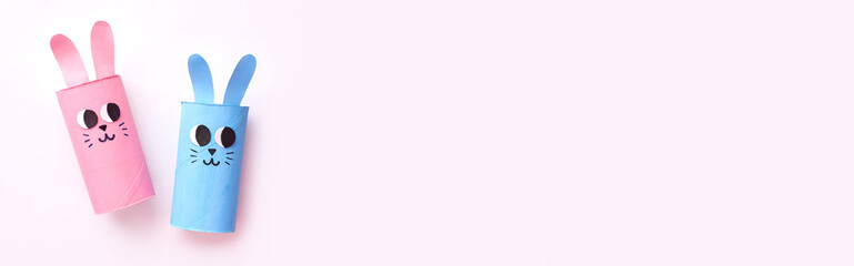 Holiday easy DIY craft idea for kids. Toilet paper roll tube toy's cute rabbit's on minimal background banner. Creative Easter, Christmas decoration eco-friendly, reuse, recycle handmade concept