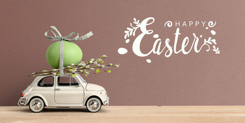 Retro car carrying an easter egg on the roof. Happy Easter lettering