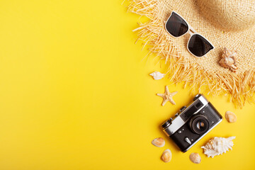 Straw hat sunglesses film camera on yellow background vacation travel planning mockup