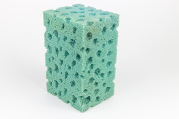 Green sponges for washing dishes on a white background close-up