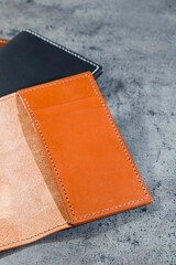 Black leather cardholder on a gray background. Handmade leather products.